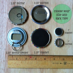 May include: An assortment of round accessories, including a 2.25-inch mirror, button, bottle opener, and magnet, along with a 1-inch magnet and button. A wooden ruler is placed next to the items for size comparison. The text "Choose your size and back type" is also visible.