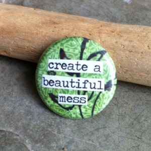 May include: Green button with white text that reads "create a beautiful mess".
