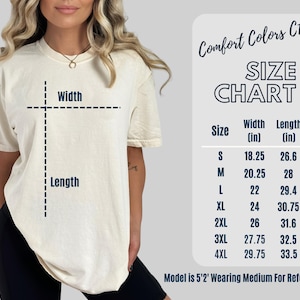 May include: Cream-colored t-shirt with a size chart. The chart lists sizes S to 4XL, with width and length measurements in inches. The text "Comfort Colors C1717" is at the top. The model is 5'2" and wearing a medium for reference.