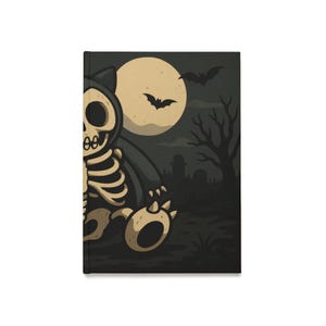 May include: A Halloween-themed notebook featuring a cartoon skeleton bear design. The bear is set against a backdrop of a full moon, bats, and a spooky graveyard scene. The cover is black with a matte finish.