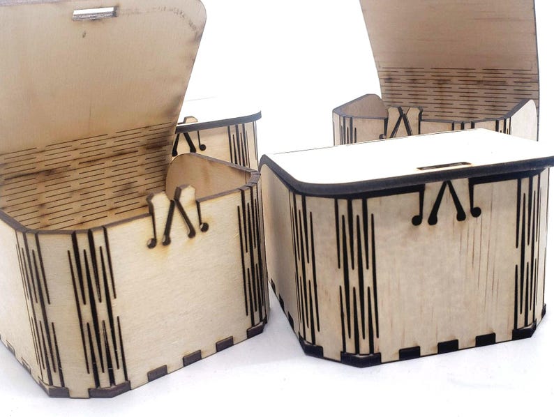 A small wooden craft box with laser‑cut details sits ready to decorate, showing the smooth unfinished wood that makes these boxes perfect for DIY kits. Their simple shape invites painting, stickers, and creative designs, making them ideal for kids’ crafts, party activities, and personalized gifts that feel handmade and meaningful.