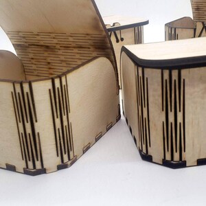 A small wooden craft box with laser‑cut details sits ready to decorate, showing the smooth unfinished wood that makes these boxes perfect for DIY kits. Their simple, customizable design invites painting, stickers, and creative projects, making them great for kids’ crafts, party activities, and personalized handmade gifts.