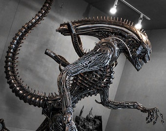 May include: A detailed sculpture of an alien creature made entirely of metal parts, such as screws, bolts, and gears. The sculpture is posed in a dynamic stance, with its tail curled up behind it. The alien's head is slightly tilted, and its mouth is open in a menacing snarl. The sculpture is a striking example of the artist's creativity and skill.
