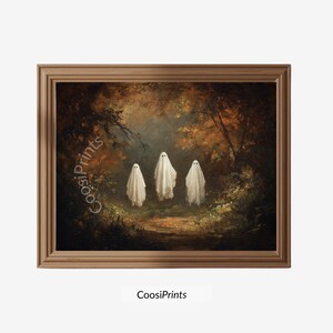 Könnte beinhalten: Ein gerahmter Kunstdruck mit drei weißen, in Laken gehüllten Geisterfiguren in einem dunklen herbstlichen Wald mit orangefarbenem und braunem Laub. Der Text CoosiPrints ist links im Bild und unter dem Rahmen zu sehen.