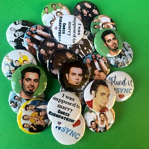 May include: A collection of round buttons with images of a boy band and text. Some buttons feature portraits, while others display group photos. Text on the buttons includes "I was supposed to marry Chris Kirkpatrick" and "Fluent in Sync."