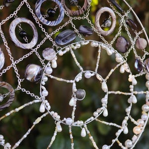 Mermaid inspired spiral wall hanging with nautical shell details and silver charm centre.
