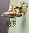 Brass Copper Nautical Bulkhead Wall Sconce – 11” Marine Cage Light – Industrial Outdoor Lamp for Bathroom, Porch, or Coastal Decor product logo