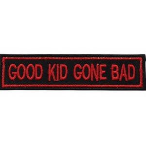 May include: A rectangular black patch with the words "GOOD KID GONE BAD" embroidered in red. The patch has a red border and is likely designed to be sewn onto clothing or accessories.