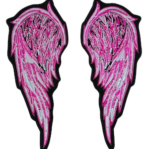 May include: Two embroidered angel wing patches. The wings are predominantly hot pink with white detailing, set against a black border. These patches are likely designed for application on clothing or accessories.