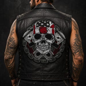 May include: A black leather waistcoat featuring a large embroidered back patch of a skull wearing a bandana with an American flag pattern. The skull is flanked by two engine pistons and encircled by a heavy metal chain design in black and grey.