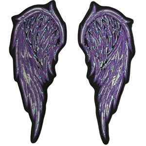 May include: Pair of embroidered purple angel wing patches with silver accents and small blue rhinestones. The wings have a black border and are designed for sewing or ironing onto fabric. Ideal for jackets, bags, or other apparel.