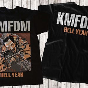 May include: Black t-shirts with the band name "KMFDM" in silver block letters. The front shirt has a graphic of a man holding a phone with the words "HELL YEAH" below. The back shirt has "KMFDM" and "HELL YEAH".