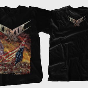 May include: Black t-shirt featuring a graphic print of a band called "Toxic" with an American flag and a building in the background. The back of the shirt has the band's name printed in white.