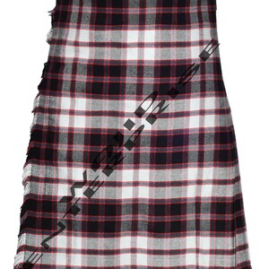 May include: A tartan kilt in a classic plaid pattern of black, white, and red. The kilt features a fringed edge along the side. The fabric is woven in a traditional Scottish design.