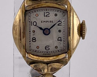 Reloj rectangular Empire Swiss para mujer, década de 1950, tono dorado, con pulsera expandible.