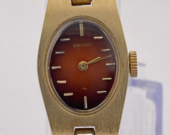 Seiko Women's Quartz Watch 1E20-6039 – Gold Tone Oval Case – Black