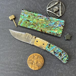 Handmade Damascus Steel Folding Knife: Abalone Shell & Brass Guard