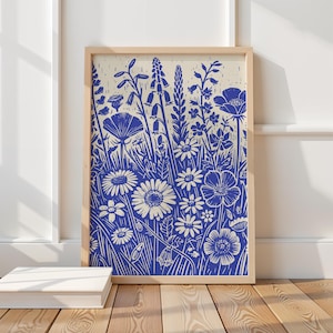 May include: A blue and white floral print with a variety of flowers and plants. The print is in a wooden frame.