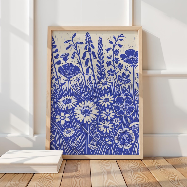 May include: A blue and white floral print with a variety of flowers and plants. The print is in a wooden frame.