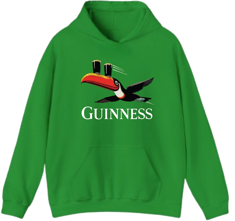 May include: Green hooded sweatshirt featuring a toucan carrying two pints of Guinness. The toucan has a red, orange, and black beak and wings. The word "GUINNESS" is printed in white below the bird.