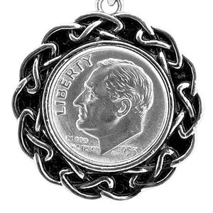 May include: A silver pendant featuring a 1953 US dime coin surrounded by a black Celtic knot design.