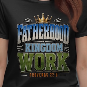 Peut inclure: T-shirt noir avec l'inscription "FATHERHOOD KINGDOM WORK" dans une police vieillie, surmontée d'une couronne dorée. Le texte "PROVERBES 22:6" est en bas. Le t-shirt a des accents bleus et verts.