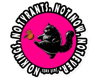 May include: A black cat wearing a crown kicks a small orange fruit. The background is pink with the text "NOT KINGS, NOT TYRANTS. NOT NOW, NOT EVER. JUST CATS" in a white circle.