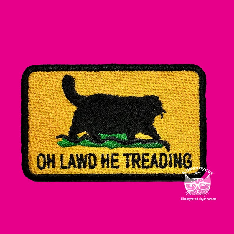 May include: A yellow and black embroidered patch with a black cat silhouette and the text "OH LAWD HE TREADING".