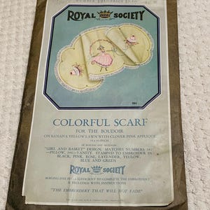 May include: Vintage Royal Society scarf kit. The package features a colorful scarf design for the boudoir, with a banana yellow lawn and clover pink applique. The scarf measures 18 x 45 inches. The kit includes instructions and boiling dye floss.