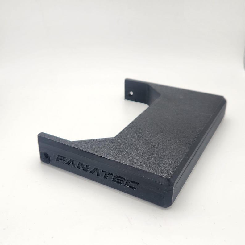 May include: A black plastic mounting bracket with the word "FANATEC" embossed on the side.
