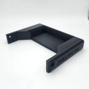 May include: A black plastic holder with the text "Vinyl Tech" printed on the side. The holder has a rectangular opening and two small holes on the sides.
