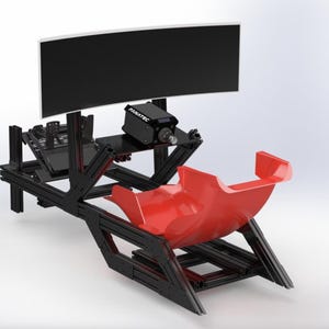 May include: A black racing simulator setup with a curved monitor and a red seat. The simulator has a black frame and a "FANATEC" logo on the equipment.