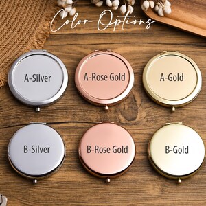 May include: A collection of six round compact mirrors in silver, rose gold, and gold finishes. Each mirror is labeled with a letter and color name, such as "A-Silver" and "B-Gold". The text "Color Options" is displayed in a script font.