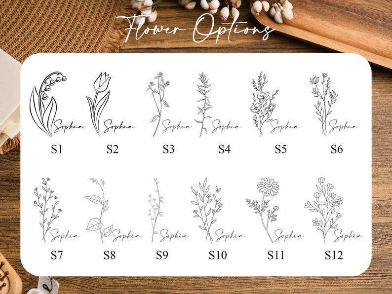 May include: A white card displays twelve delicate black line drawings of various flowers, each labeled with "Sophia" in cursive. The card is titled "Flower Options" in cursive. Each flower is numbered from S1 to S12.