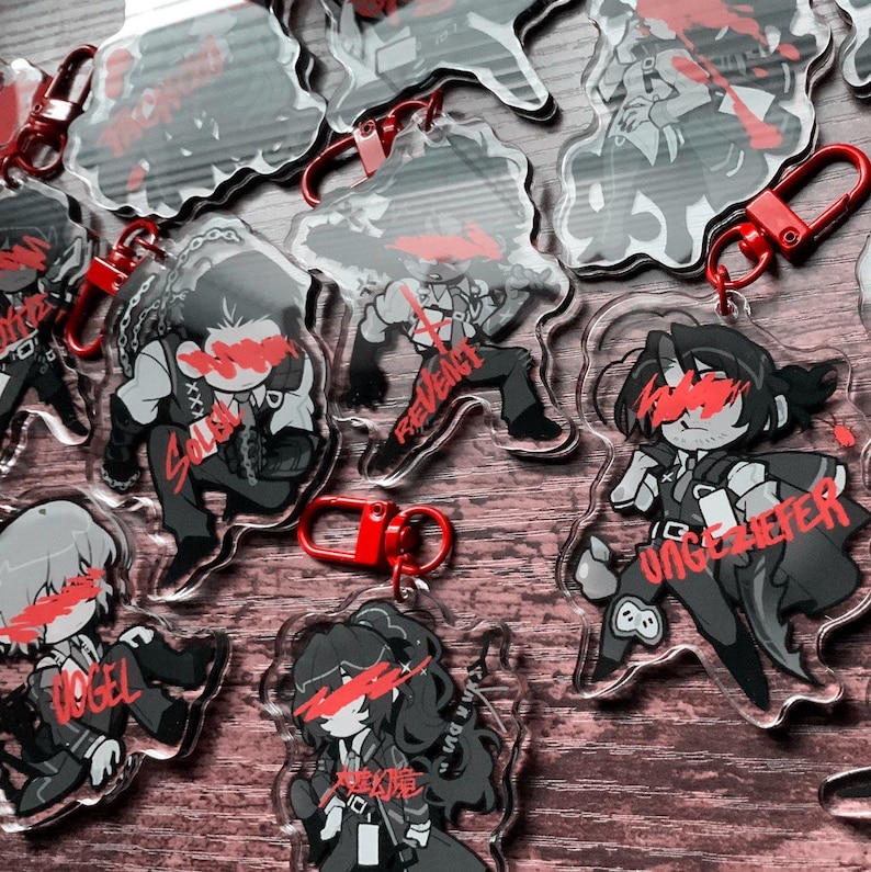 May include: A set of eight clear acrylic keychains featuring black and white illustrations of characters with red accents. Each keychain has a different character with a unique name, including "Vogel", "Salbei", "Revenant", "Ungez&uuml;fer", and "R&auml;uberin".