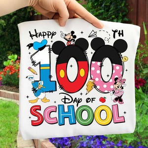 May include: White tote bag with the text "Happy 100th Day of School" featuring Mickey and Minnie Mouse, Donald Duck, and school-themed graphics. The numbers "100" are designed with Mickey Mouse ears.