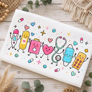 May include: A white fabric featuring a colorful cartoon print of medical items with faces, including a thermometer, bandage, first aid kit, heart, stethoscope, face mask, and pill blister pack, surrounded by small stars, hearts, and pills.