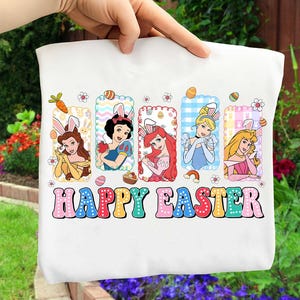 May include: White tote bag featuring five Disney princesses wearing bunny ears, with the text "HAPPY EASTER" in colorful letters. The princesses are in rectangular frames with Easter egg and flower details.