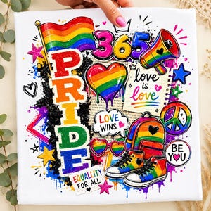 May include: A white fabric surface featuring a colorful graphic print with the word PRIDE in large vertical letters, a rainbow flag, a heart, a megaphone, a backpack, sneakers, and the text love is love, LOVE WINS, and EQUALLITY FOR ALL.