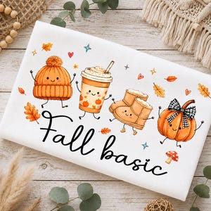 May include: A white fabric surface featuring a colourful graphic print of a smiling orange beanie, a coffee cup, tan boots, and a pumpkin with a black and white plaid bow. The text "Fall basic" is printed in black script below the illustrations.