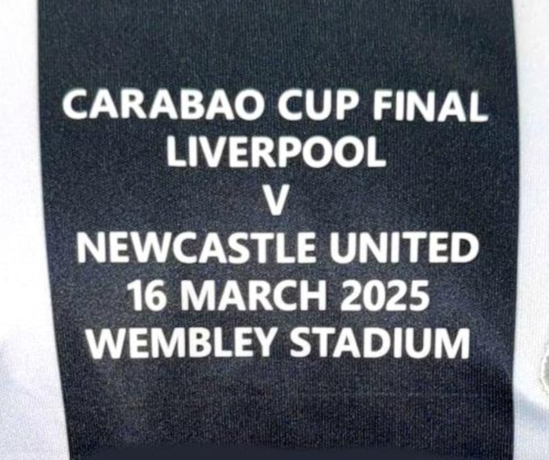 Może przedstawiać: Czarny materiał z białym tekstem ogłaszającym finał Carabao Cup pomiędzy Liverpoolem a Newcastle United 16 marca 2025 na stadionie Wembley. Tekst jest wyśrodkowany.