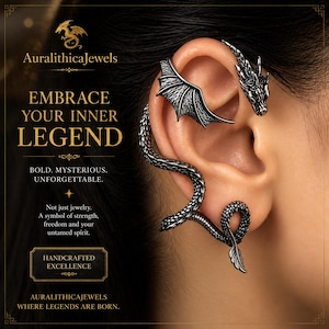 May include: A silver dragon ear cuff featuring a wing, dragon head, and a serpentine design. The image includes the text "EMBRACE YOUR INNER LEGEND" and "AuralithicaJewels". The handcrafted jewellery symbolises strength and freedom.