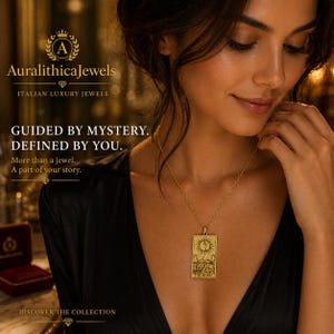 May include: A gold-colored pendant necklace featuring a rectangular charm with a detailed illustration of the moon, sun, and mountains. The necklace is displayed on a person wearing a black top. The image includes the text "Auralithica Jewels" and "Italian Luxury Jewels".
