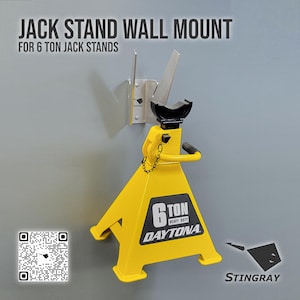May include: A yellow 6-ton Daytona jack stand with a black handle and a wall mount. The jack stand has a black top and a chain. The text "JACK STAND WALL MOUNT" is at the top of the image.