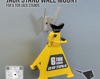 May include: A yellow 6-ton Daytona jack stand with a black handle and a wall mount. The jack stand has a black top and a chain. The text "JACK STAND WALL MOUNT" is at the top of the image.