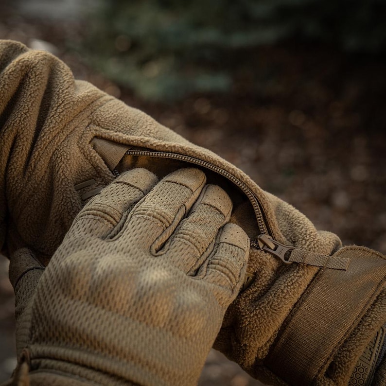 Sleeve pocket and Velcro panels on fleece jacket