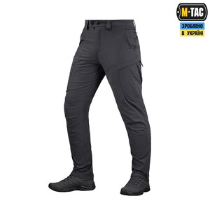 May include: Dark grey tactical trousers with multiple pockets and a button closure. The trousers are shown with black athletic shoes. The image includes the text "M-TAC" and "ЗРОБЛЕНО В УКРАЇНІ".