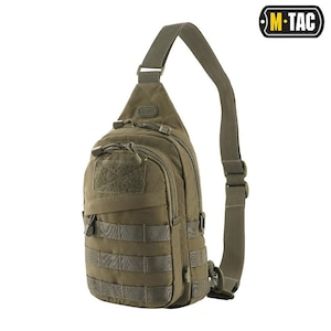 May include: Olive green sling bag with multiple compartments and MOLLE webbing. Features a shoulder strap and a patch area. The bag has a zippered main compartment and a smaller front pocket. The M-TAC logo is visible in the upper right corner.