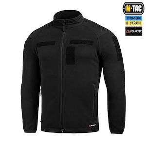 May include: Black fleece jacket with a full-length zipper and a stand-up collar. The jacket features multiple Velcro patches and a small zippered pocket on the chest. The Polartec logo is visible on the lower right side.
