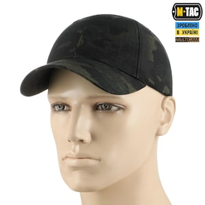 May include: A black and green camouflage baseball cap with a curved brim. The cap is made of a durable fabric and features a structured crown. The M-TAC logo and text are visible on the side.